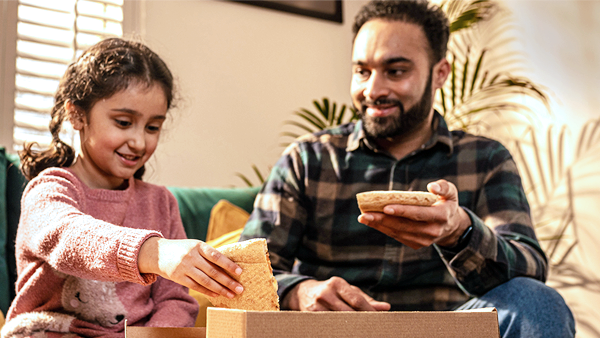 man and girl eat pizza from cardboard pizza box