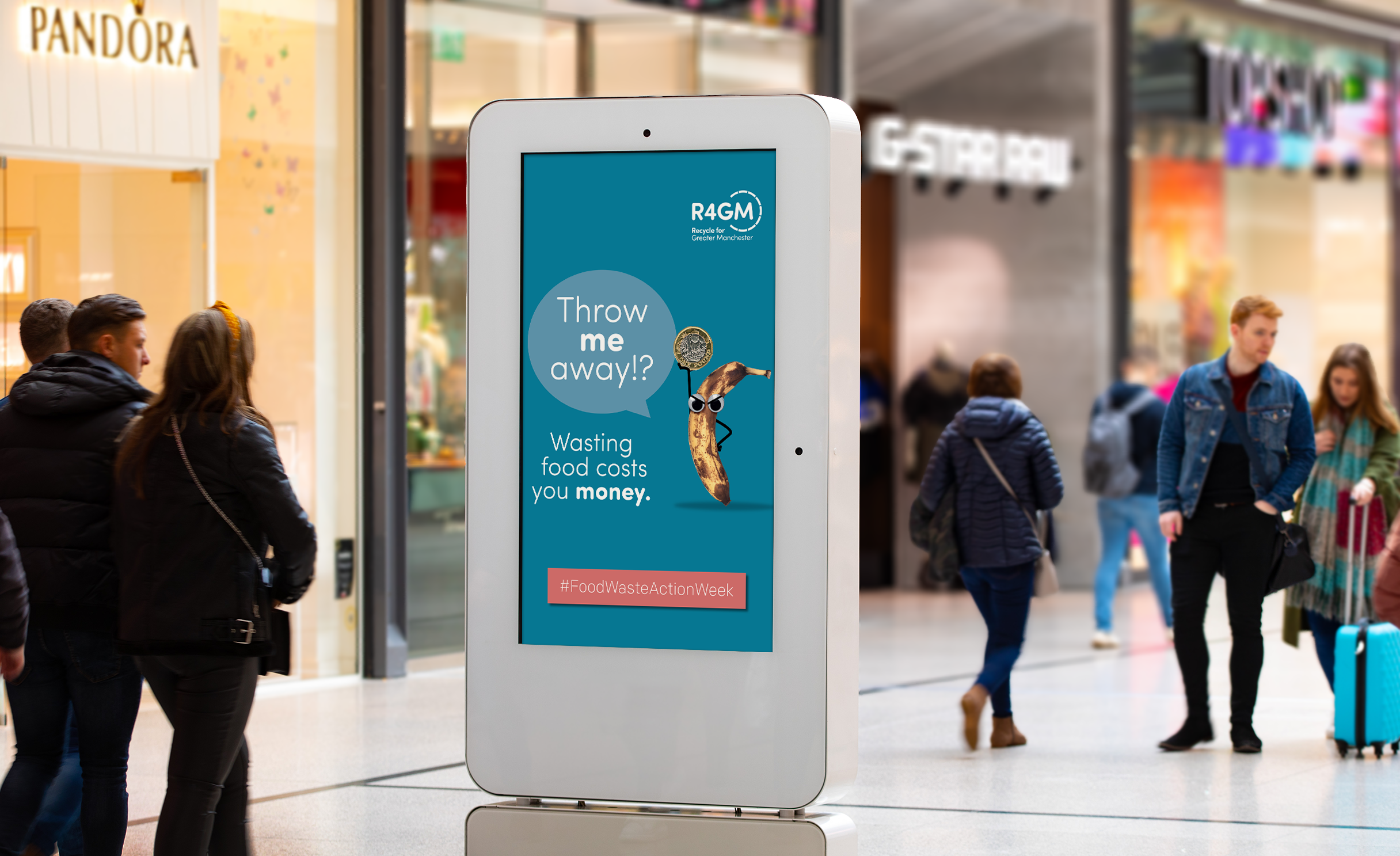 Digital display in Manchester Arndale Centre showing an R4GM campaign poster reading "Throw me away!? Wasting food costs money. #FoodWasteActionWeek"