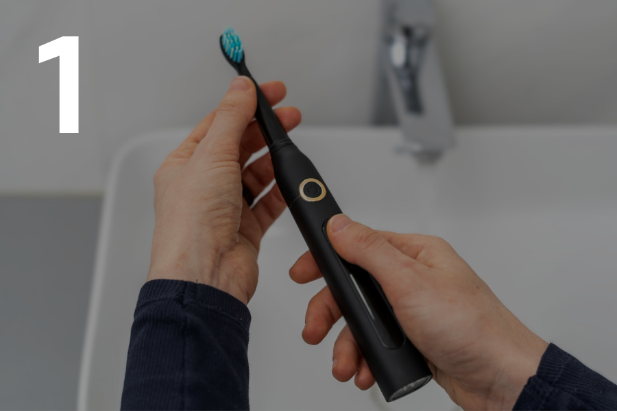 1. Person holding an electrical toothbrush