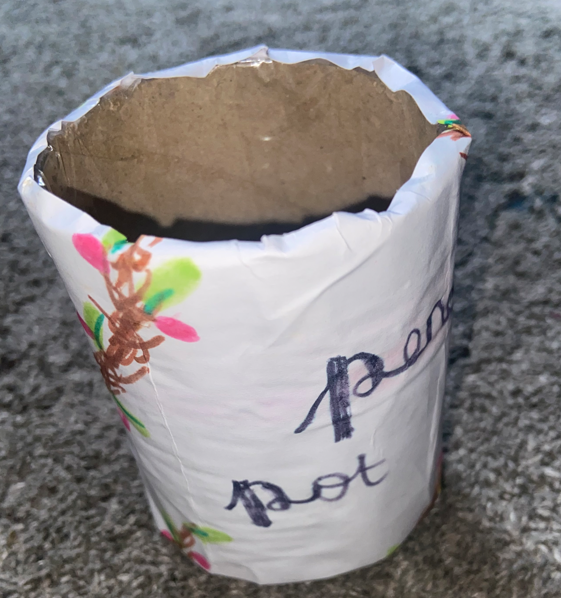 I made a pencil pot out of a toilet roll and drew branches with pink dots and green leaves
