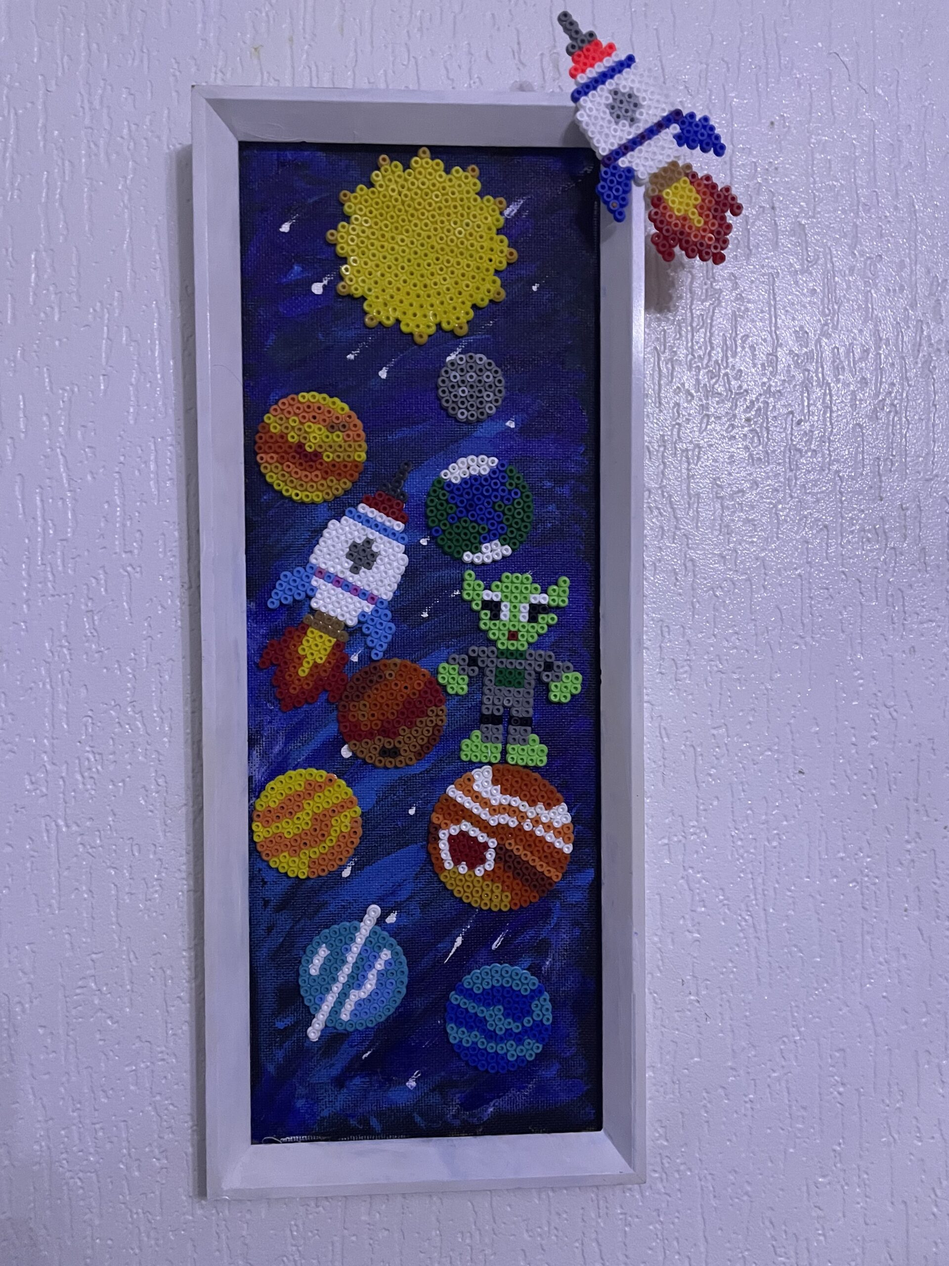 We reused an old mirror frame and made a Solar system picture with some fun elements.