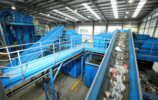 wide angle shot of Materials Recovery Facility. Conveyor belts of recycling in motion.