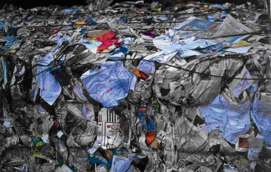 A bale of paper and card recycling bound together with cables