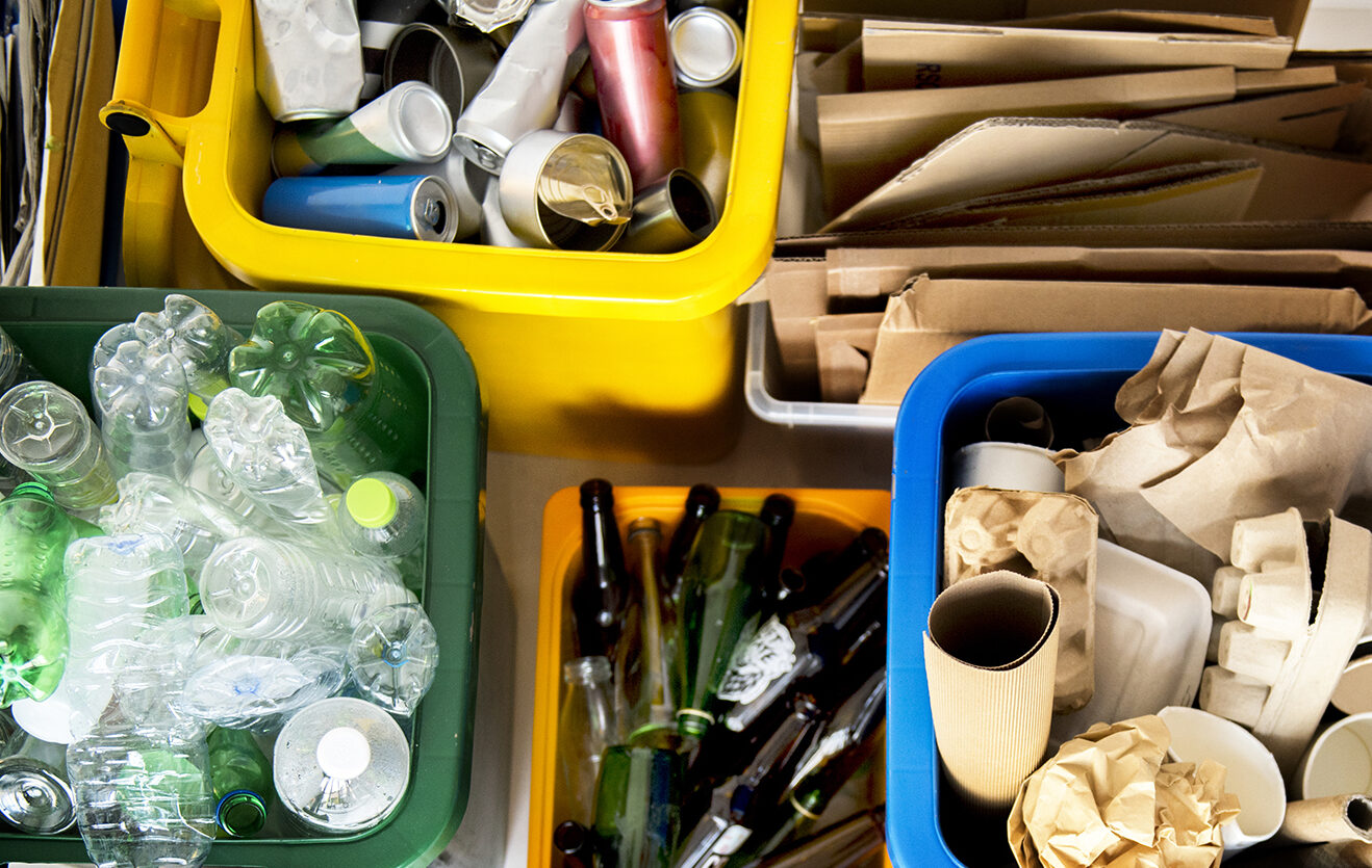 a selection of recyclable items: card, paper, plastics, aluminium.