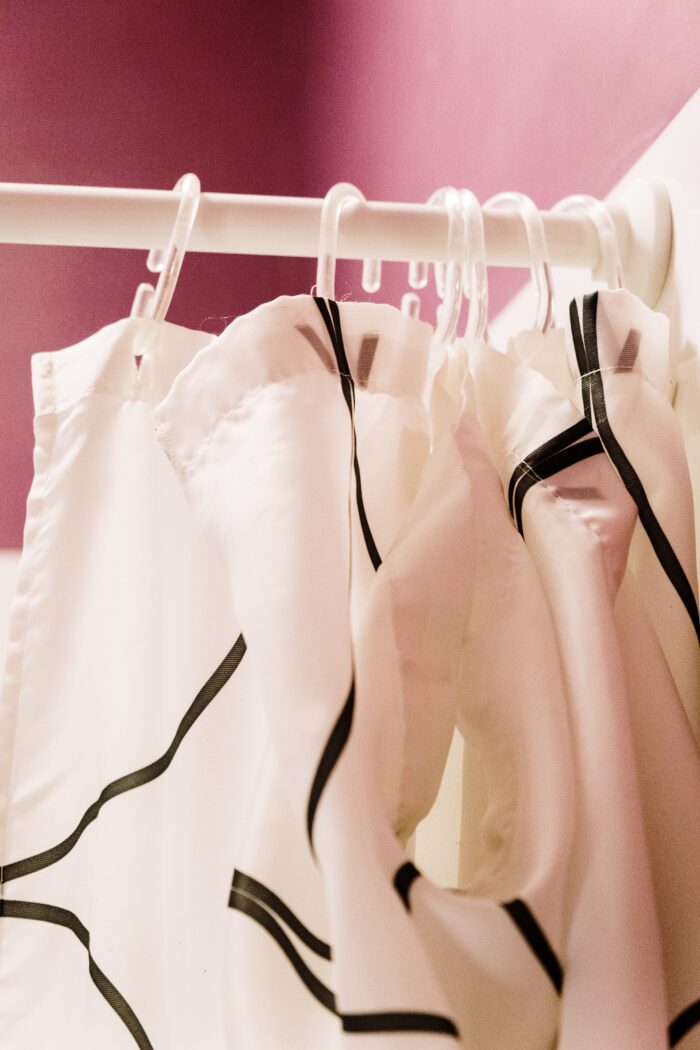 White curtain with abstract black lines, hanging on a white curtain rail
