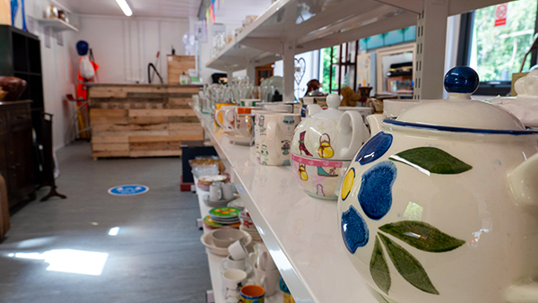 Shelf full of pottery