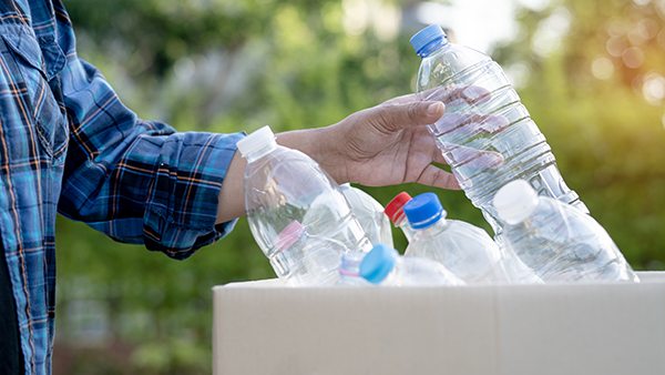 Person recycling plastic bottles